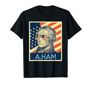 Hamilton wearing sunglasses with Us flag background shirt