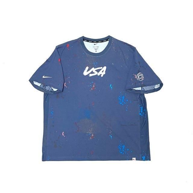 <div>Nike</div>S/S PRINT T-SHIRT<br>2024OLYMPIC/FUTURA<br>DRI-FIT<br>L.BLUE