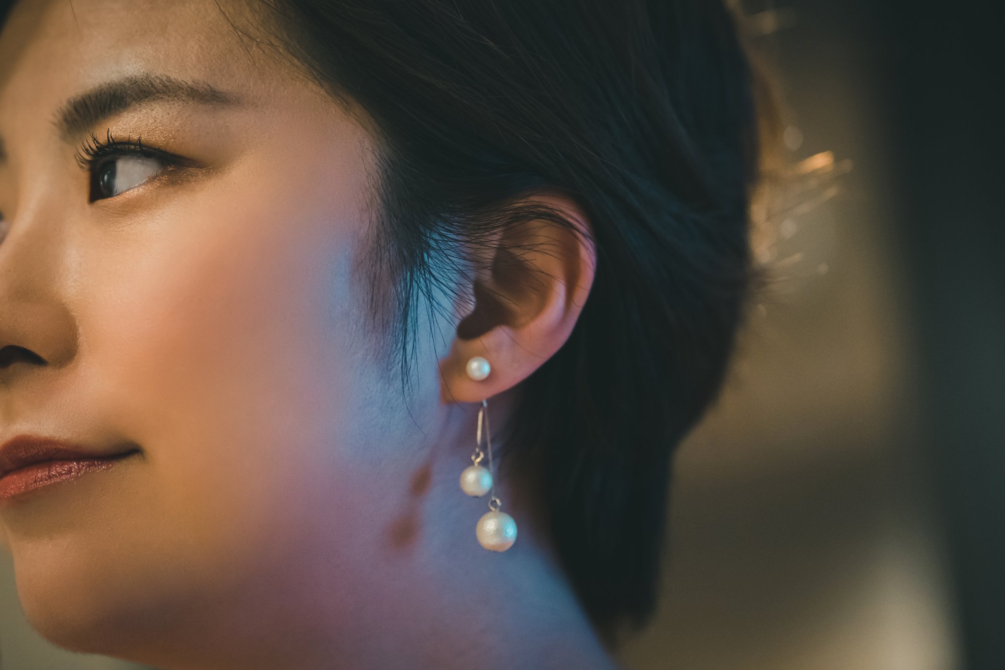 beauty and jewelery concept - woman wearing shiny diamond earrings