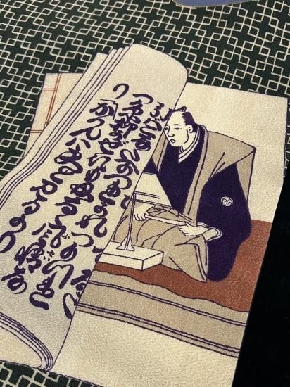 冊子に三味線・太夫文様 縮緬地 染 名古屋帯」(新品・仕立て上り) - 正尚堂